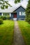 Small family house with green lawn and decorative flowers at the door