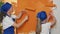 Small family painting apartment walls with orange color