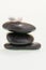 Small feather on black zen stones