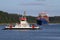 Small ferry and container ship on Kiel Canal