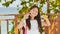 A small filipino schoolgirl shows spinning spinners. Tropical landscape. Summer. Childhood.