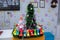 Small fir-tree , snowman . candies . Vintage snowman small figurine and a Christmas tree . snowman in a colorfull hat and scarf on