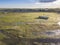 Small fisherman boat in Ria Formosa Natural Park during low tide