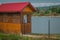 small fishermen cabin on a lake for catching fish. Visible also other cottages or cabins around the lake