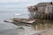 Small fishing boat anchored beside the over water stilt Bajau shanty houses.