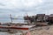 Small fishing boat anchored beside the over water stilt Bajau shanty houses. Long shot