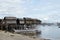 Small fishing boat anchored beside the over water stilt Bajau shanty houses. Long shot