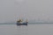 A small fishing boat is anchored. Stop back from Fishing near the coast