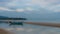 Small fishing boat and dingy sitting in tidal pool at low tide