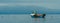 Small Fishing Boat With Lobster Pods And Seagulls On Calm Atlantic In Front Of The Hebride Islands