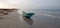 Small fishing boat reflecting in sunset light on Nilaveli beach in Trincomalee Sri Lanka