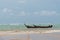 Small fishing boat in a storm near beach