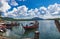 Small fishing boat with Thai woman docked to Pier