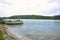 Small fishing boats docking at wooden pier in rural area of Lake Conjola, Australia.