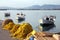 Small fishing boats floating in the pretty harbor in Nafplio in Greece with nets