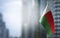 A small flag of Madagascar on the background of a blurred background