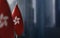 Small flags of Hong Kong on a blurry background of the city