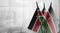 Small flags of the Kenya on an abstract blurry background