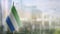 Small flags of the Sierra Leone on an abstract blurry background