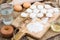 Small flour cookies on wooden board