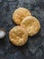 Small focaccia tortillas with sea salt on a dark background, top view