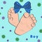 small foot of a newborn baby boy with a bow blots