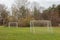 Small football field with two goals outdoors on green grass