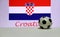 Small football on the white floor and Croatian nation flag with the text of Croatia background.