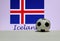 Small football on the white floor and Icelandic nation flag with the text of Iceland background.