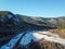 A small forest river at the beginning of winter. The river froze because of the winter cold. The river began to freeze