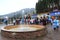 Small fountain in Bukovel in Carpathian mountains. People having a rest in resort town