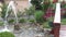 Small fountain in the courtyard, decorative flowers in the back