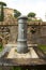 A small fountain of fresh and clean water for drinking on one of the streets of Rome in Italy. Classic Roman fountain with