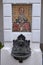 Small fountain and religious mosaic in monastery yard, Serbia