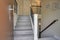 Small foyer design boasts a gray wood staircase