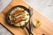 Small fried Bavarian German NÃ¼rnberger sausages with sauerkraut, mashed potatoes and mustard in iron cast pan on marble table