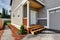 Small front porch with stairs and white entrance door.