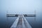 Small frosted wooden jetty over the water