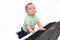 Small funny boy playing electric piano