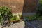 Small garden of potted plants in an alley