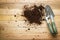 Small gardening shovel and fork on wooden background