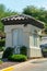 Small gaurd tower or building with visible windows and adobe roof tiles in afternoon sun with white stucco exterior