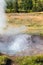 Small geyser in Haukadalur valley in Iceland