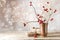 Small gift parcels and rosehip branches on a rustic wooden table