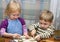 Small girl and the boy help on kitchen