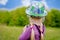 Small girl in a colorful outfit on a country track