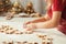 Small girl cutting out from rolled dough Christmas cookies. Holiday baking family celebration