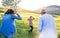 A small girl with her senior grandparents having fun outside in nature.