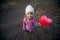 Small girl with inflatable red heart