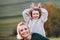 Small girl with mother on a walk in autumn nature, having fun.